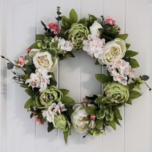Faux flower wreath with green colors