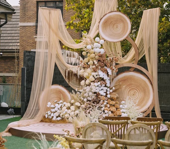 Artificial Flowers for Wedding 12 Bohemian style wedding backdrop featuring artificial floral arrangements and rustic wood slice decorations