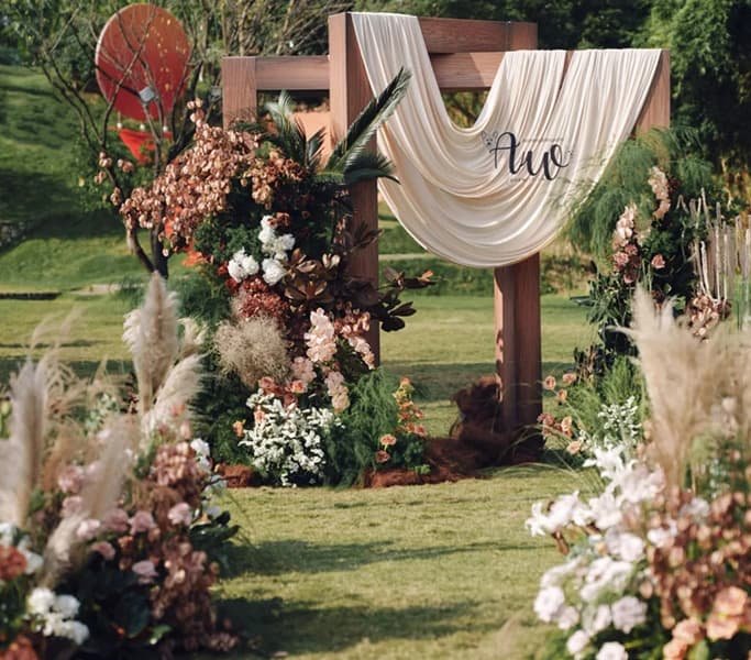 Artificial Flowers for Wedding 10 Rustic outdoor wedding altar with artificial autumn floral arrangements and flowing cream fabric